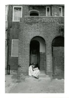 Photograph: Girl reading in doorway