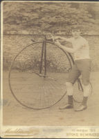 Photograph of young man and penny farthing bicycle