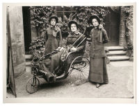 A photograph of three women, one in a wheelchair