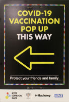 Sign: COVID-19 VACCINATION POP UP THIS WAY